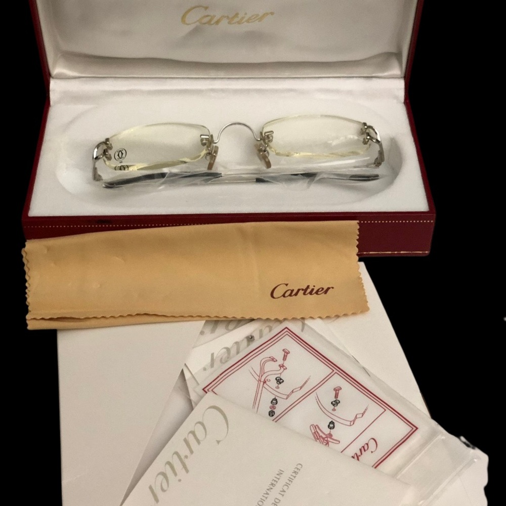 silver frameless Cartier  glasses.